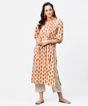Off white & red printed 3/4th sleeve cotton pleated a-line kurta with beige pallazo