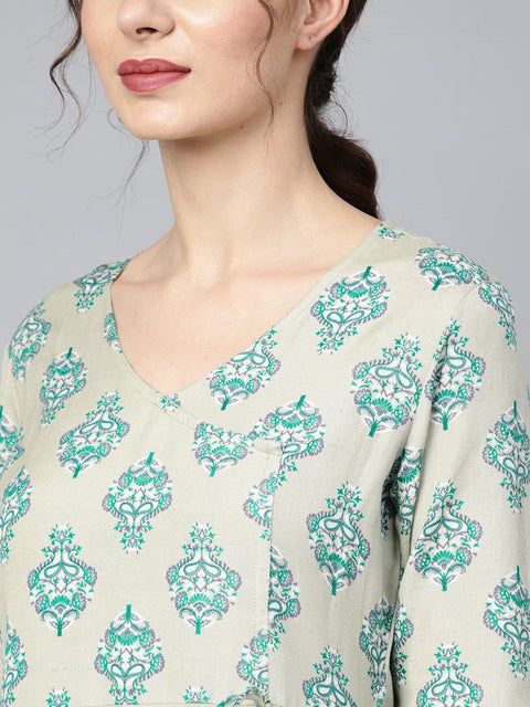 Sage green printed V-neck Angrakha style 3/4th assymetrical sleeve falred kurta with solid pants.
